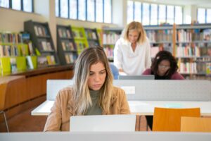 Student girl working on research, studying and gathering data on a laptop.
